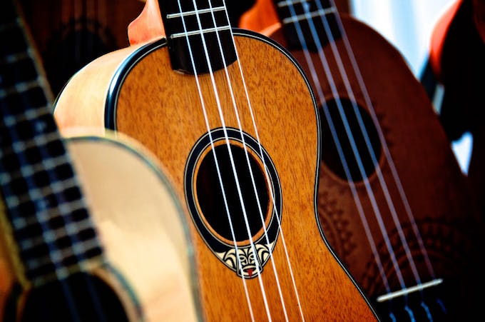 A close up shot of three guitars in a row