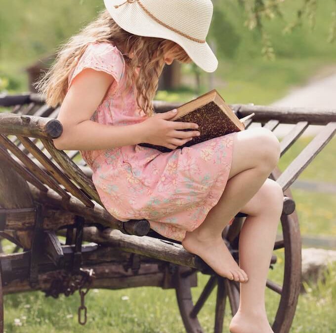 Photo of a girl reading a book filled with myths and legends.